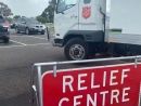 A Salvos relief truck next to a relief centre sign