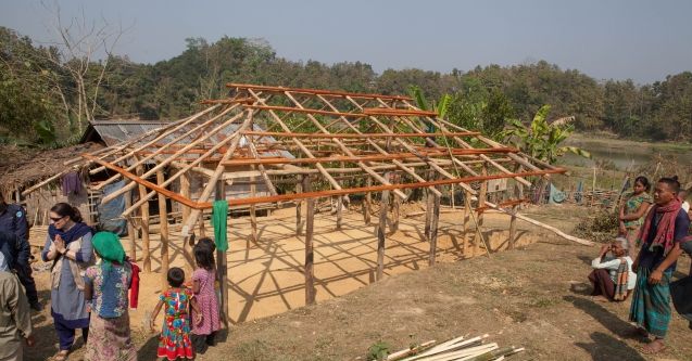 Builders construct a house in landslide-affected Bangladesh