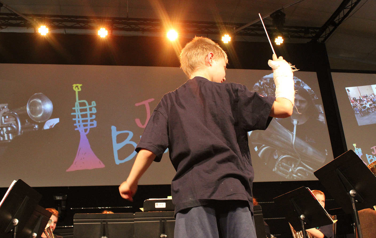 young boy conducting