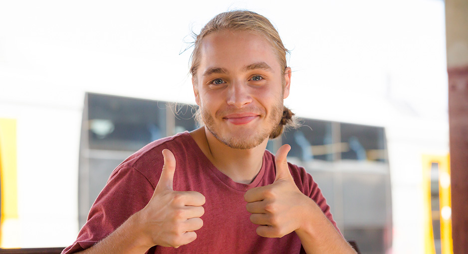 Young man giving two thumbs up